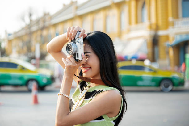seorang wanita muda menggunakan kamera mirrorless