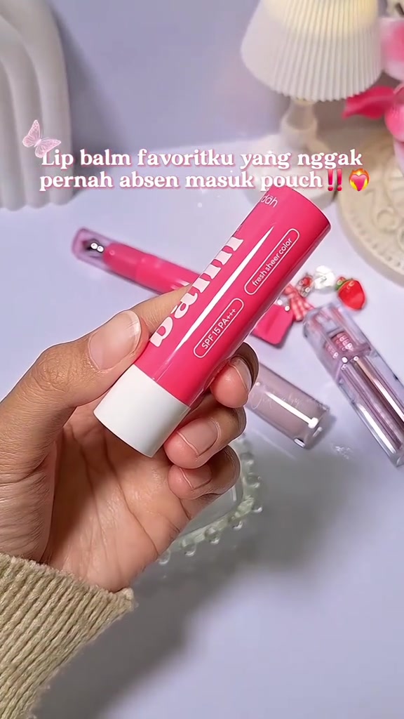 Tangan memegang stick Wardah Hydra Balm warna pink dengan label SPF 15 PA+++ terbaca jelas