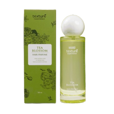 Botol hijau Makarizo Texture Experience Hair Perfume varian Tea Blossom berdampingan dengan kotaknya